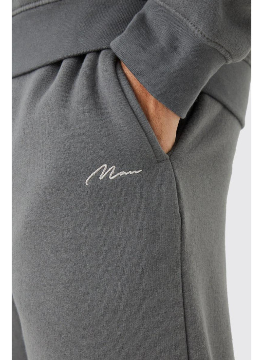 Чоловічий фірмовий спортивний костюм із подовженою горловиною і розділеним подолом